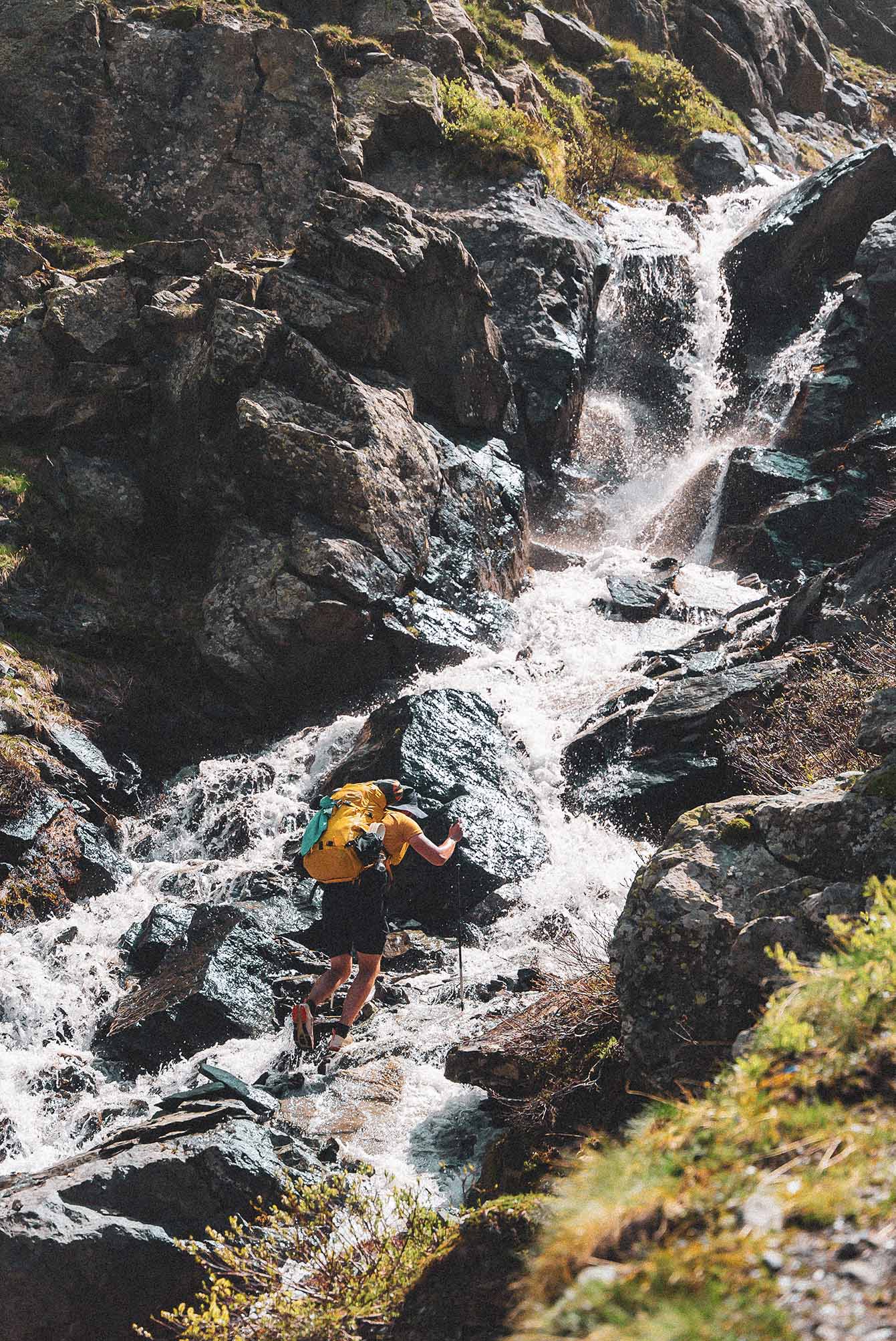 Randonneur près d'une cascade en montagne
